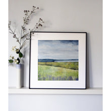 Load image into Gallery viewer, Framed landscape painting on a white wall with decorative branches and flowers.
